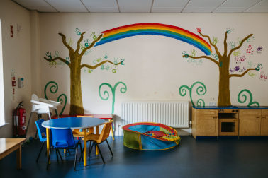 Children's play area at Depaul's Family Service with colourful rainbow mural on the wall