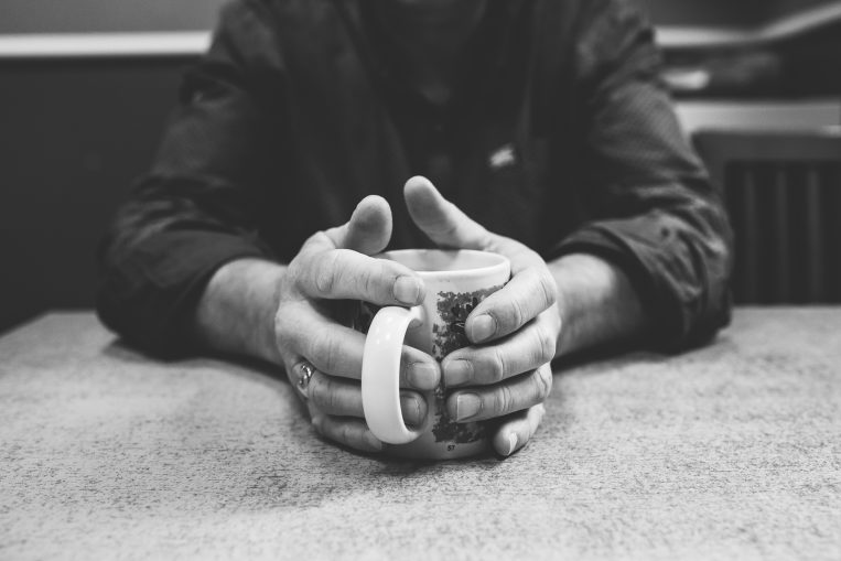 Depaul service user holding a mug of tea in black and white