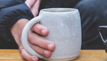 Depaul homeless service user holds a mug of hot tea